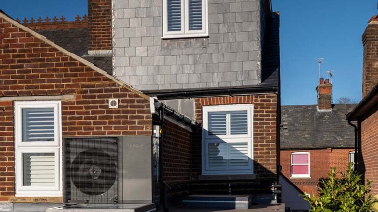 Heat pump installed on the side of a house