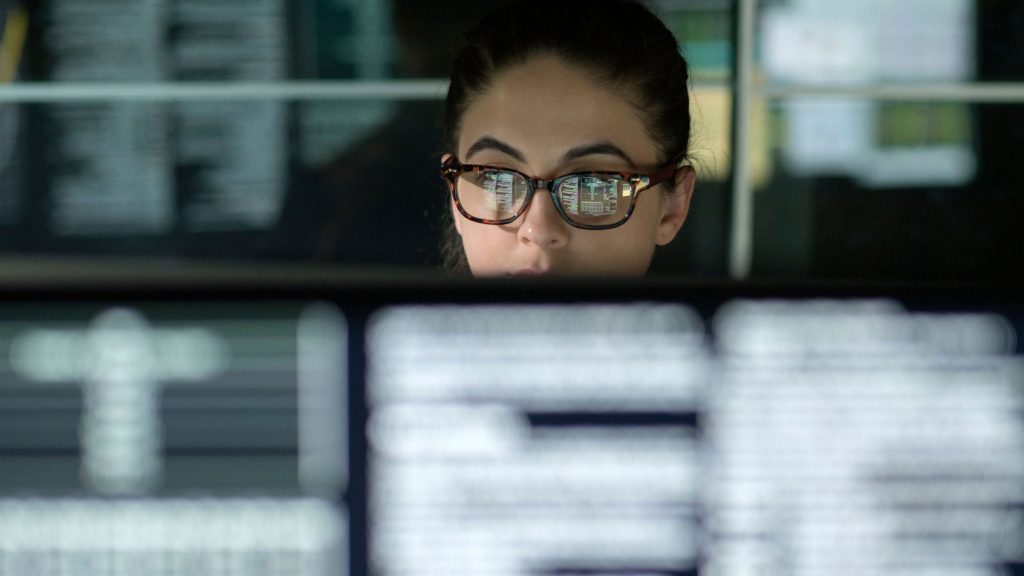 woman reading code off computer screen