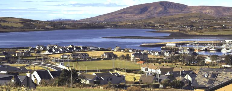 View of houses, lake and mountains