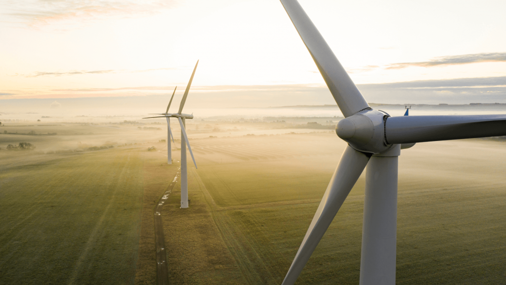 large windmills on foggy field