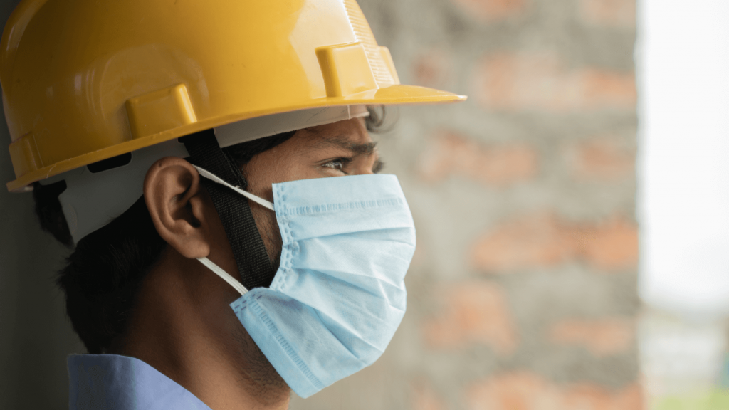 Man in hard hat with face mask