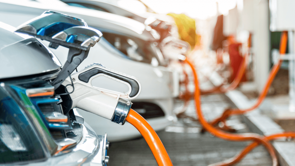 cars plugged into charging station