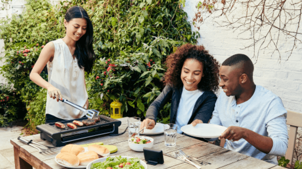 friends enjoying a meal together, smart meter on table