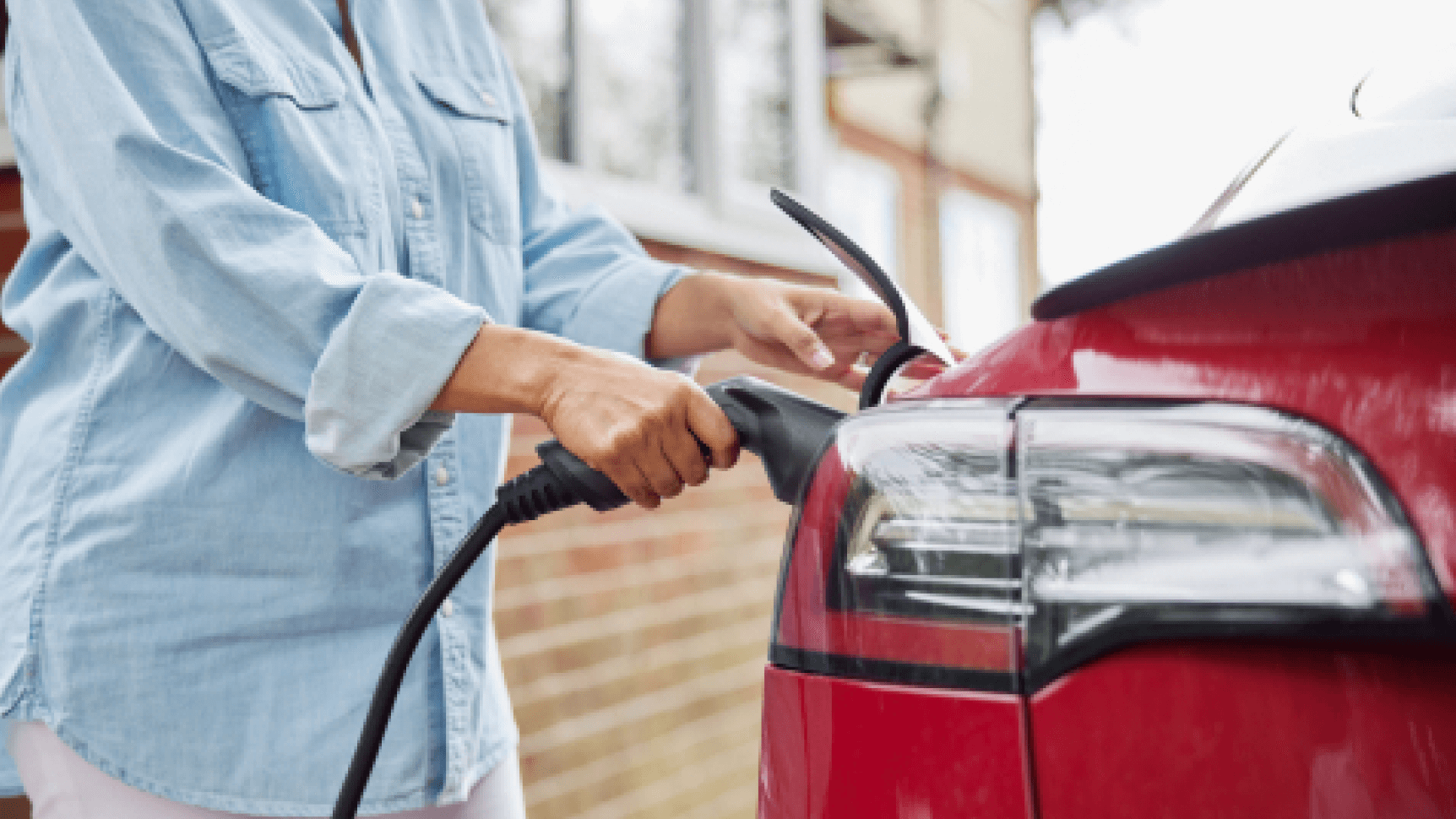 woman charging an electric car