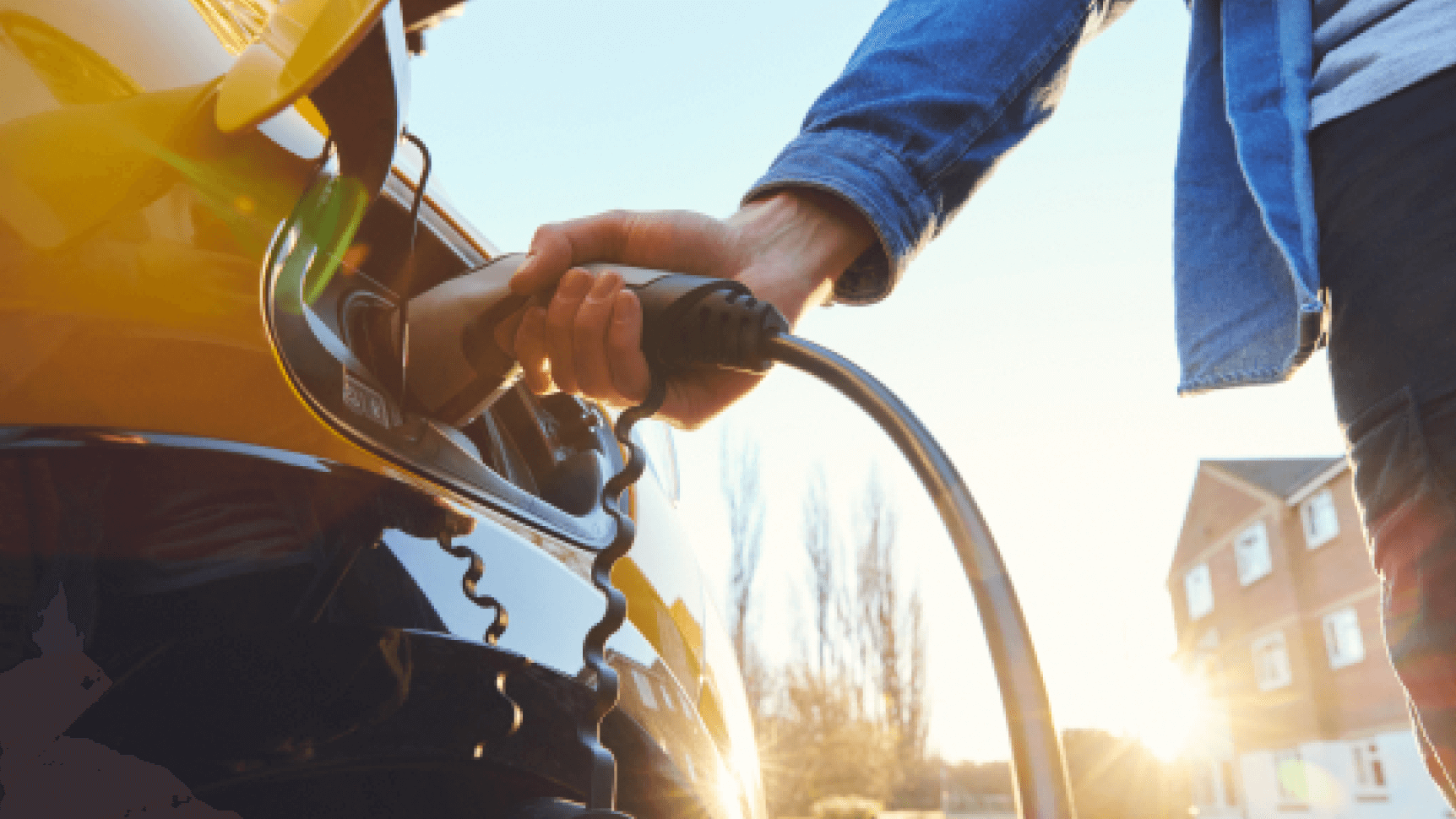 electric car being charged by owner